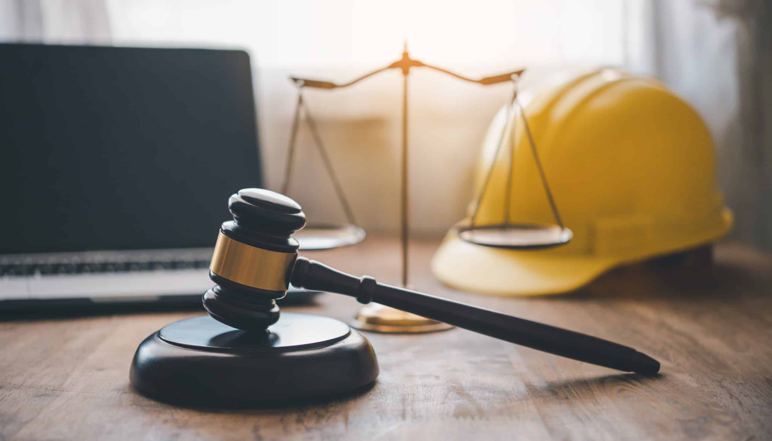 Judge's hammer and helmet Law and Justice about labor law concep